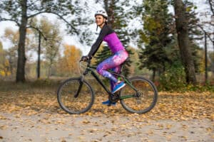 image of woman in park wearing best cycling baselayer for women