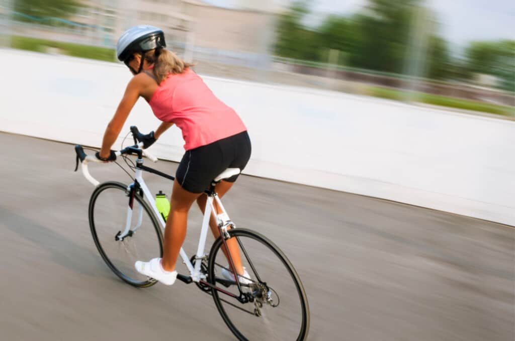 Image of Woman on bike wearing triathlon shorts