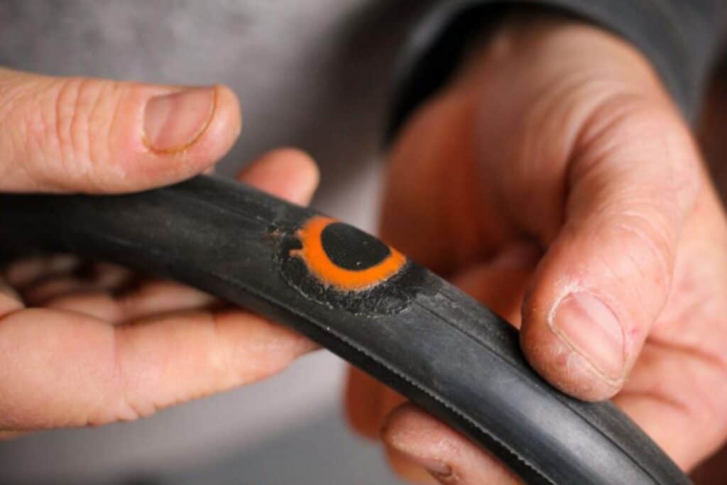Image showing progress on how to fix a bike tube patch applied
