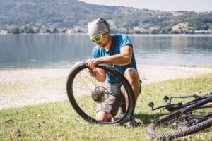 Image of man near water showing how do you fix a bike tube