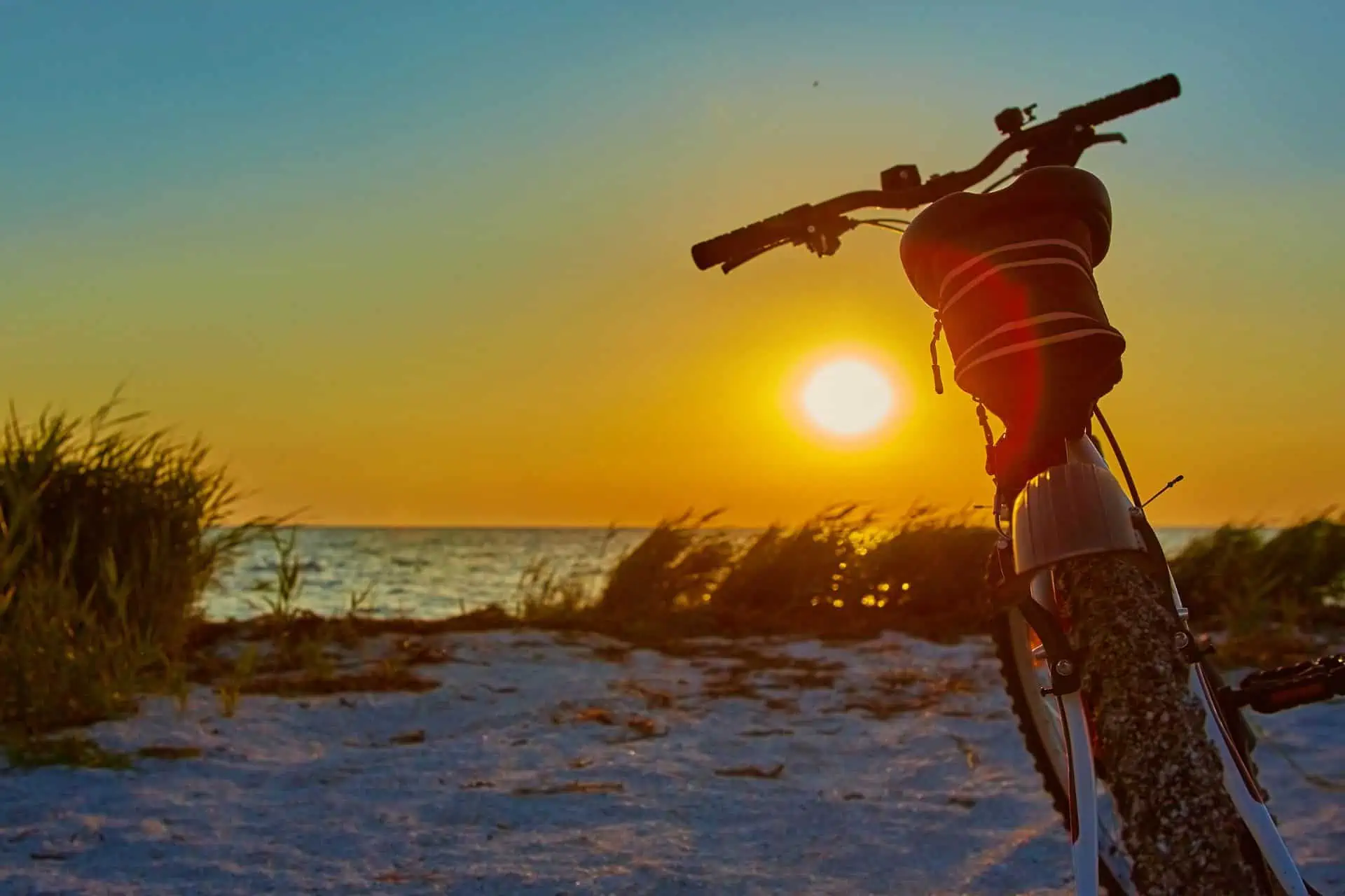 Image of bike on beach sun shining reaturing Cycling Sun Protection